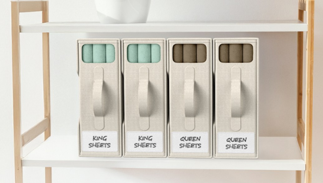 Sheet organizers stored under a bed and on an open shelf